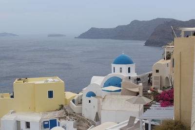 Panoramic view of sea and buildings against sky