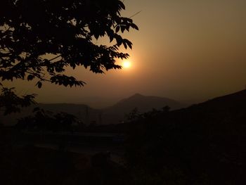 Scenic view of silhouette mountains against sky at sunset