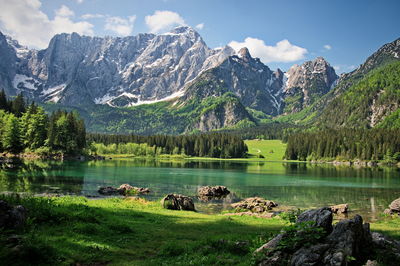 Scenic view of laghi di fusine lake with italian alps in background