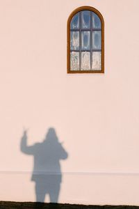 Low angle view of a womans shadow on the wall