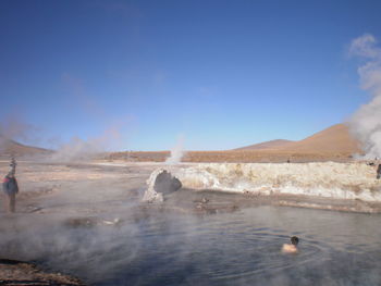 Rear view of shirtless man in hot spring at tatio geysers