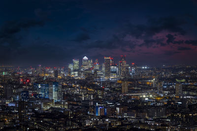 Illuminated cityscape against sky at night