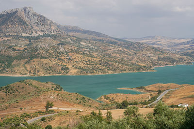 Scenic view of sea and mountains against sky