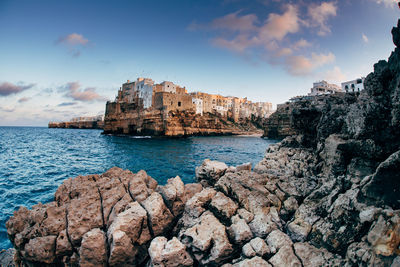 View of town by sea against sky