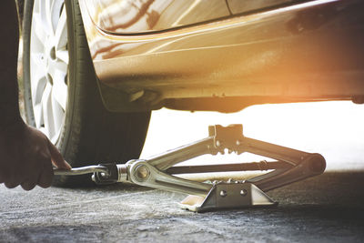 Close-up of person working on motorcycle