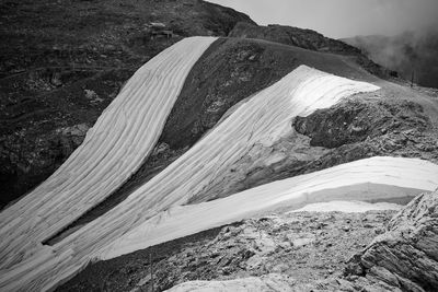 Artificial covering of the glacier due to climate change and to extend the ski season.