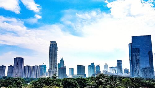 View of skyscrapers against cloudy sky