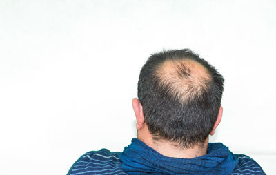 Rear view of man against white background