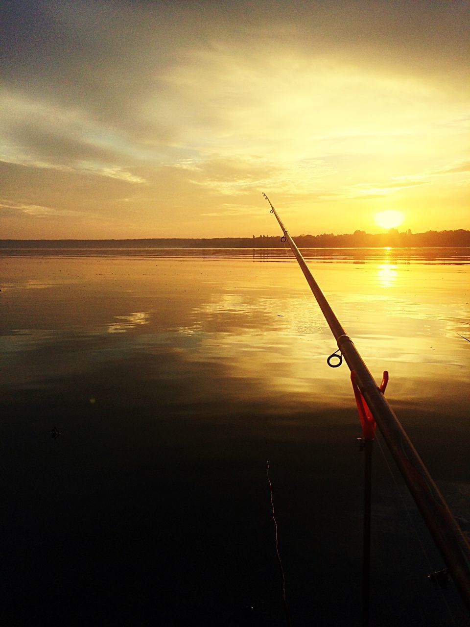 water, sunset, sea, fishing, reflection, horizon over water, outdoors, nature, sky, no people, tranquility, fishing pole, beauty in nature, fishing tackle, day