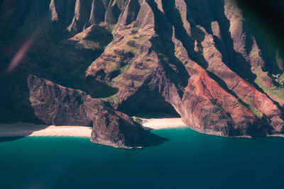 Scenic view of rock mountains by sea