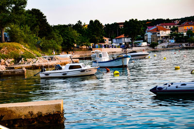 Boats moored in river