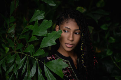 Portrait of young woman with leaves