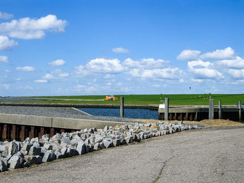 Pier on lake against blue sky