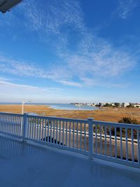 Scenic view of beach against blue sky