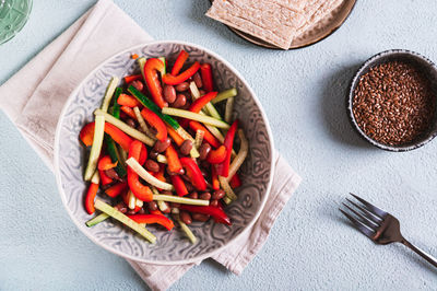 Vegetarian salad of red beans, cucumber and bell pepper in a bowl on the table top view