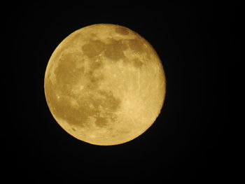Low angle view of moon against clear sky at night
