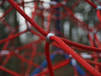 Close-up of red rope tied at playground