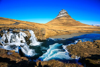 Scenic view of sea against clear blue sky