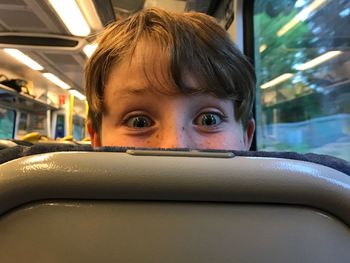 Cropped portrait of boy in train