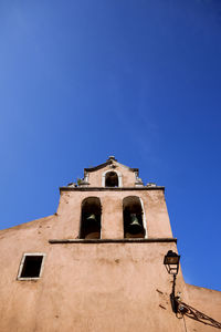 Low angle view of building against clear blue sky