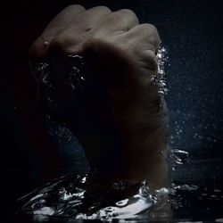 Close-up of woman hand in water