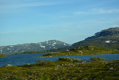 Scenic view of lake and mountains against sky