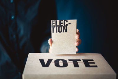 Close-up of hand holding voting ballot