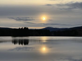 Scenic view of lake against sky during sunset