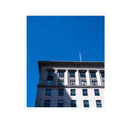 Low angle view of building against clear blue sky