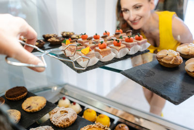 Smiling customer looking at pastry in store