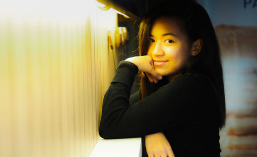 Portrait of young woman looking at camera