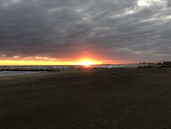 Scenic view of beach against sky during sunset