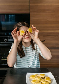 Young woman eating food on table