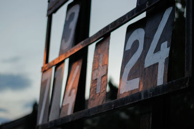 Low angle view of text on rusty metal