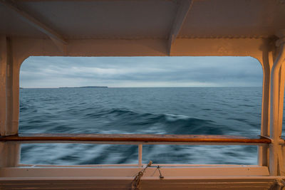 Blurred motion of sea against cloudy sky seen from ferry boat