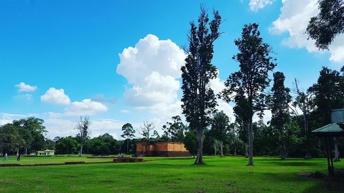 Scenic view of grassy field against cloudy sky