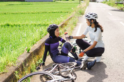 Side view of woman riding bicycle on field