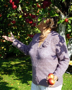 Full length of man holding apple in field