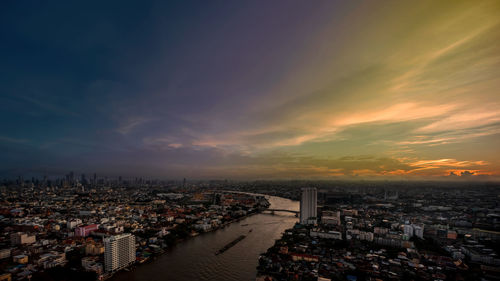 High angle shot of townscape against sky at sunset