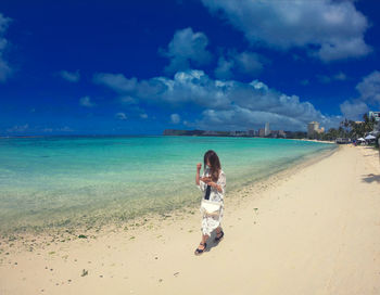 Full length of man on beach against sky