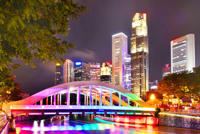 Illuminated city against clear sky at night