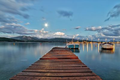 Pier over lake against sky