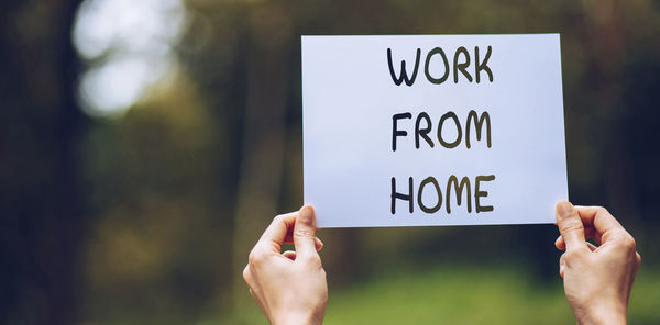 Midsection of woman holding text