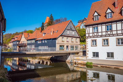 Canal amidst buildings in town against sky