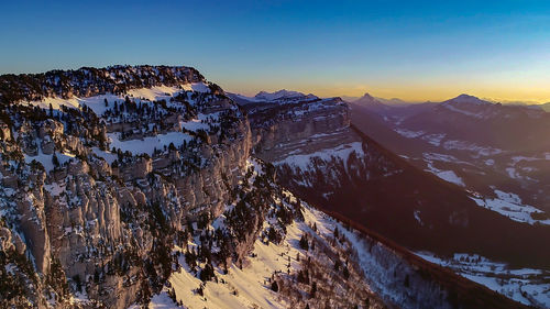 Scenic view of snowcapped mountains against sky during winter