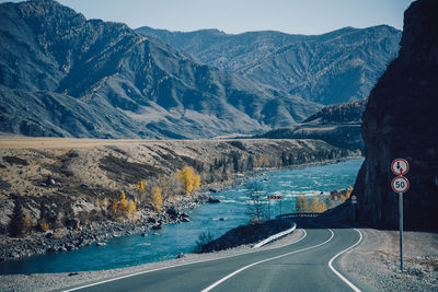 Scenic view of road by mountains