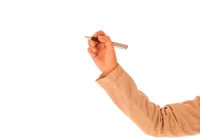 Close-up of hand holding umbrella against white background