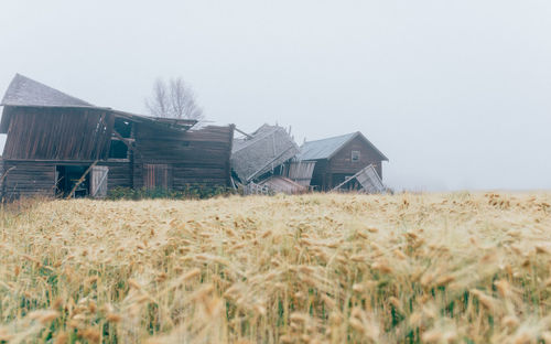 Barn on field against clear sky