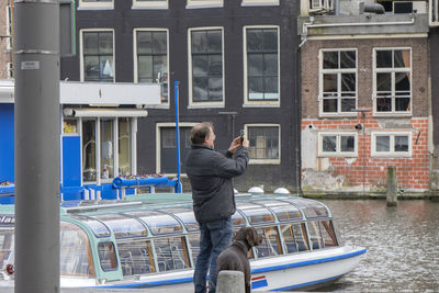 Rear view of man standing on boat