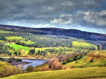 Scenic view of landscape against cloudy sky